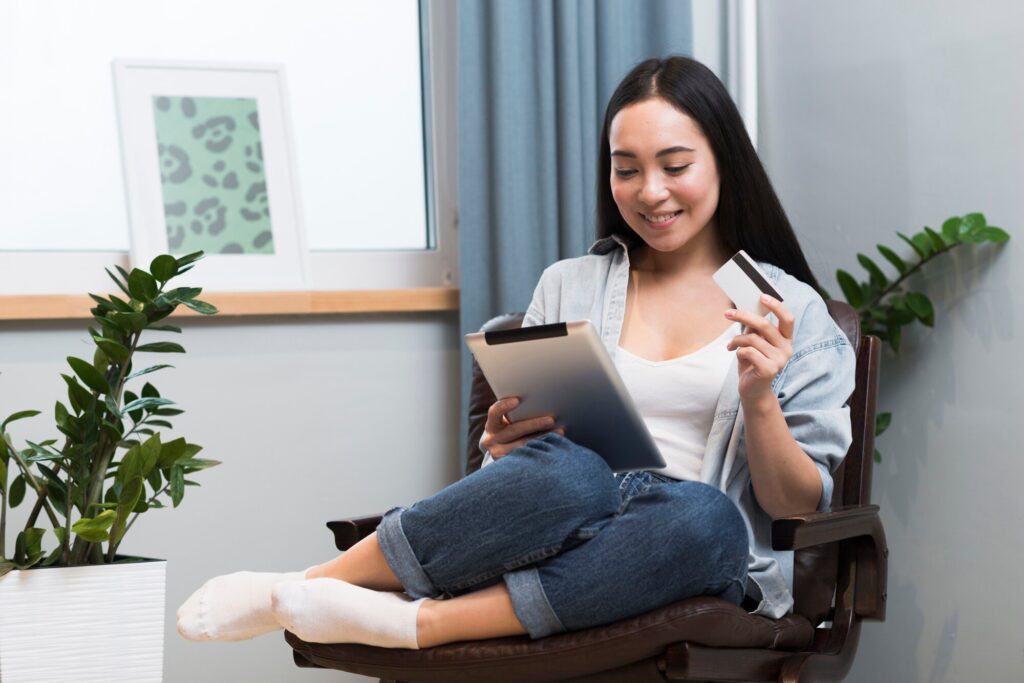 comfortable-woman-ordering-online-with-credit-card-tablet_23-2148455152